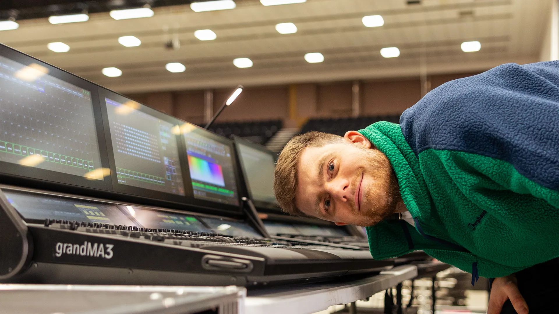 A Zeal operator at a grandMA3 lighting console mid-show.