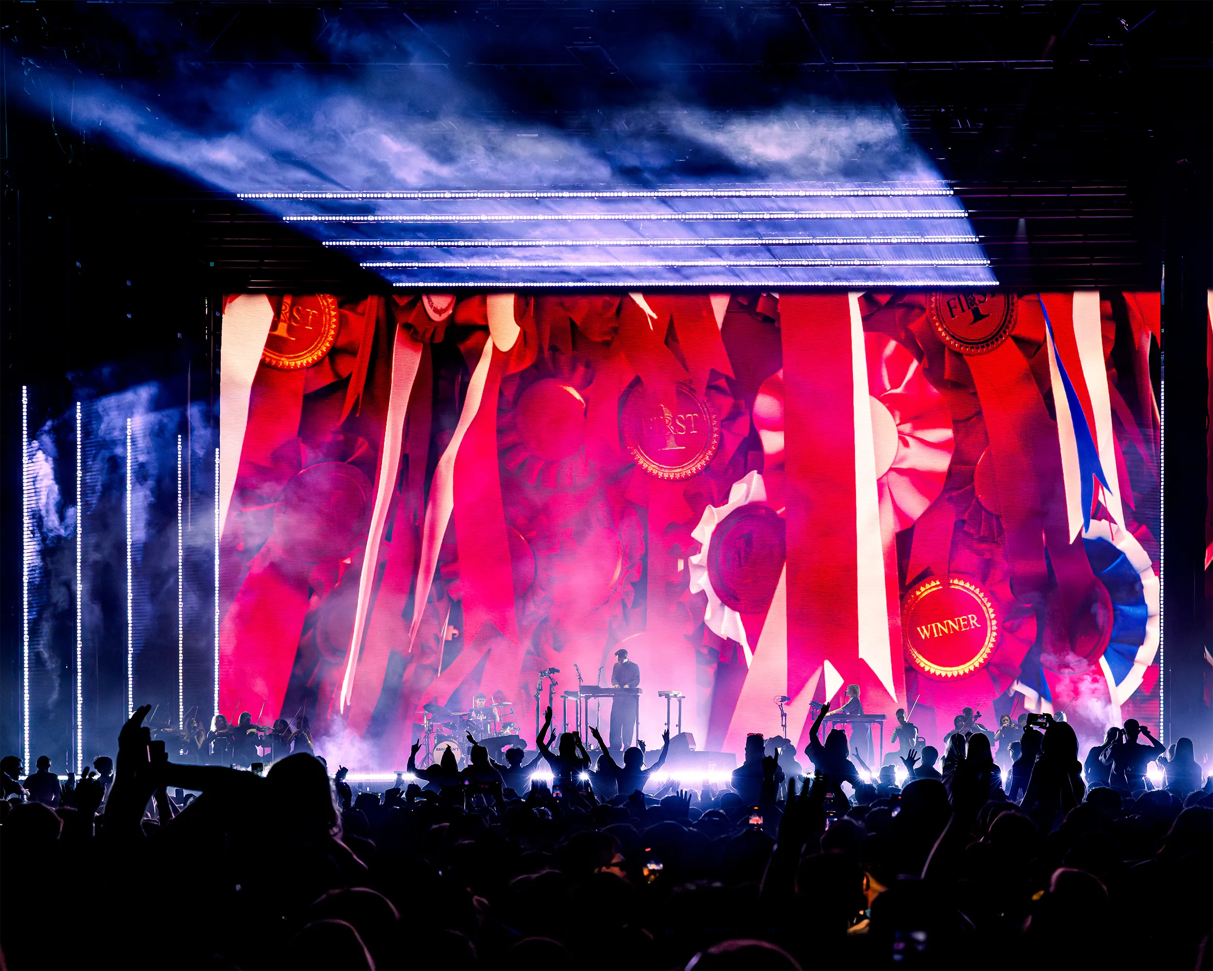 Barry Can't Swim on stage with visual art on screen behind him
