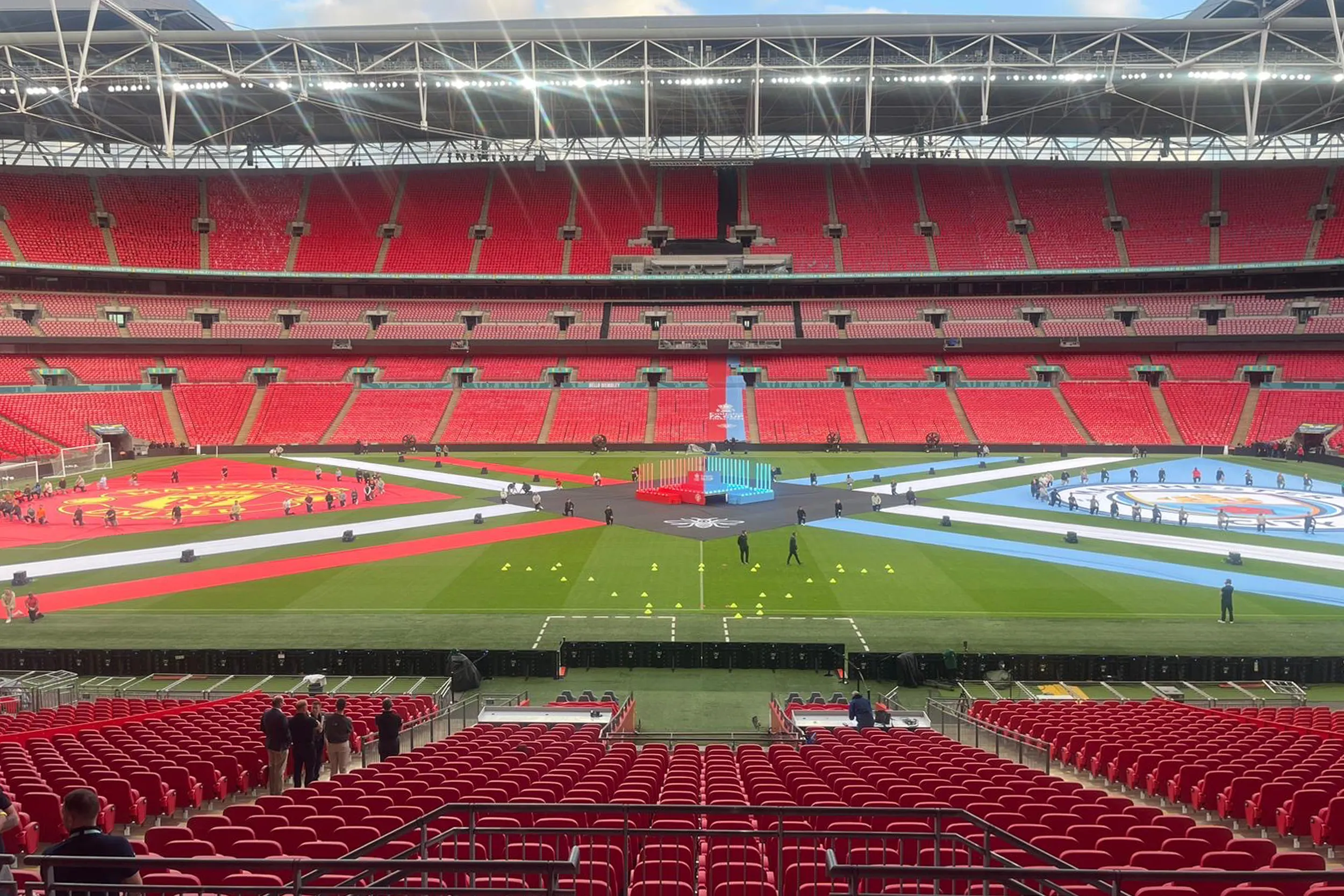 The empty stadium before kick-off, the pitch laid out with a giant red and sky blue display