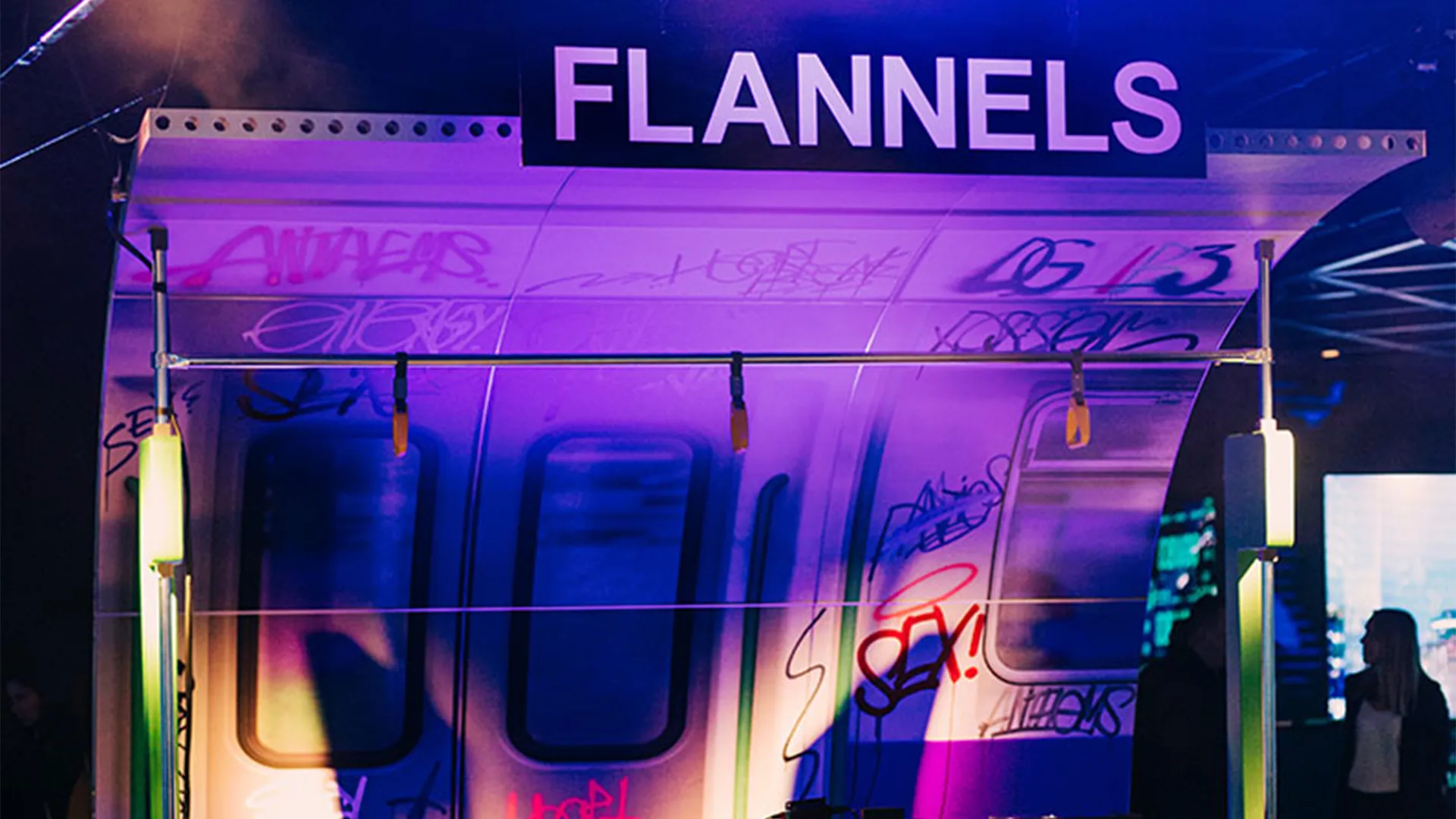 Flannels branded activation, graffitied train carriage under purple light
