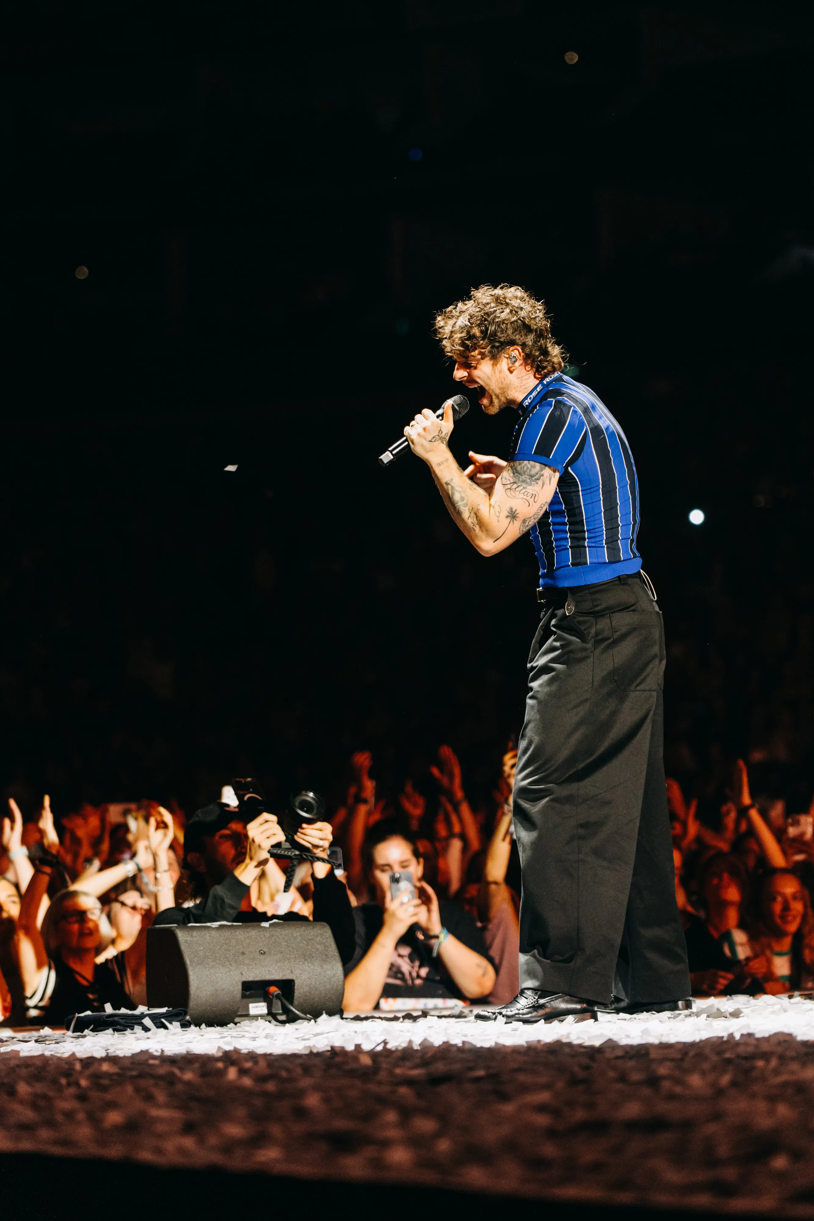 Tom Grennan performing live, mid-vocal