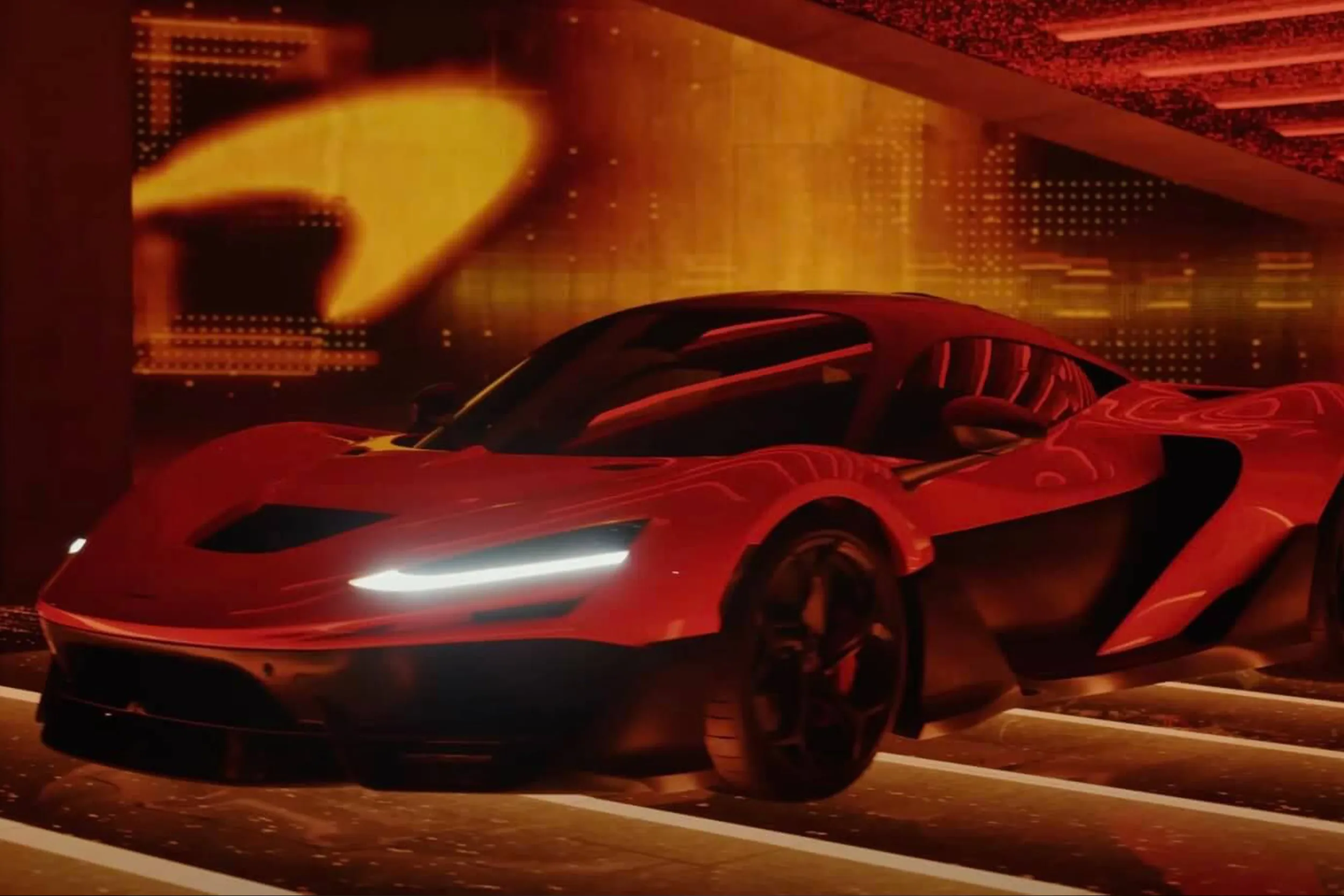 Three-quarter view of the car in red light, the McLaren swoosh glowing on the wall behind